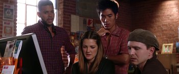Movie still from “He's Just Not That Into You” (2009), directed by Ken Kwapis – A woman sitting in front of two men in front of a brick wall; Medium shot, Over the shoulder angle