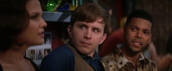 Movie still from “He's Just Not That Into You” (2009), directed by Ken Kwapis – A man with a beard and a vest looking at the camera; Close Up shot, Over the shoulder angle