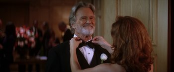 Movie still from “He's Just Not That Into You” (2009), directed by Ken Kwapis – An older man wearing a tuxedo while a woman adjusts his bow tie; Close Up shot, Low angle