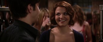 Movie still from “He's Just Not That Into You” (2009), directed by Ken Kwapis – A woman that is smiling at a party; Close Up shot, Over the shoulder angle