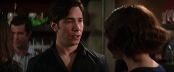 Movie still from “He's Just Not That Into You” (2009), directed by Ken Kwapis – A man in black shirt talking to another man; Close Up shot, Over the shoulder angle