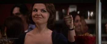 Movie still from “He's Just Not That Into You” (2009), directed by Ken Kwapis – A woman giving a thumbs up in front of a crowd; Close Up shot, Over the shoulder angle
