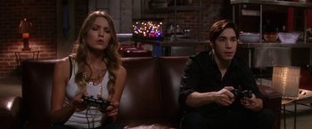 Movie still from “He's Just Not That Into You” (2009), directed by Ken Kwapis – A man and a woman sitting next to each other on a couch; Medium shot, Over the shoulder angle