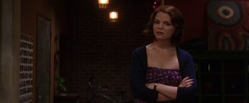 Movie still from “He's Just Not That Into You” (2009), directed by Ken Kwapis – A woman standing in front of a brick wall with her arms crossed; Medium shot, Over the shoulder angle