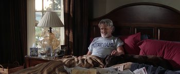 Movie still from “He's Just Not That Into You” (2009), directed by Ken Kwapis – A man sitting in a bed with a dog; Medium shot, High angle