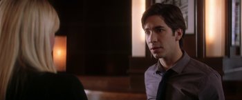 Movie still from “He's Just Not That Into You” (2009), directed by Ken Kwapis – A man sitting in front of a window looking to his left; Close Up shot, Over the shoulder angle