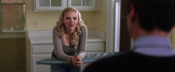 Movie still from “He's Just Not That Into You” (2009), directed by Ken Kwapis – A woman sitting in a room next to a counter; Medium shot, Over the shoulder angle