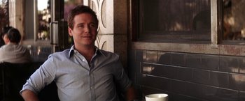 Movie still from “He's Just Not That Into You” (2009), directed by Ken Kwapis – A man sitting in front of a window with a cup of coffee; Medium shot, Over the shoulder angle