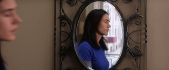 Movie still from “He's Just Not That Into You” (2009), directed by Ken Kwapis – A woman is reflected in a mirror with her eyes closed; Close Up shot, Over the shoulder angle