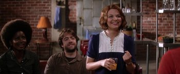 Movie still from “He's Just Not That Into You” (2009), directed by Ken Kwapis – A man and a woman standing next to each other holding drinks; Medium shot, Over the shoulder angle