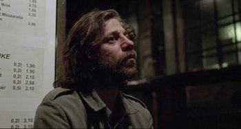 Movie still from “Head-On” (2004), directed by Fatih Akin – A man with long hair and a beard is looking up; Close Up shot, Low angle
