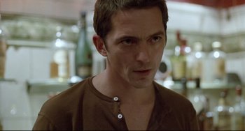 Movie still from “Head-On” (2004), directed by Fatih Akin – A person wearing a brown shirt; Close Up shot, Over the shoulder angle