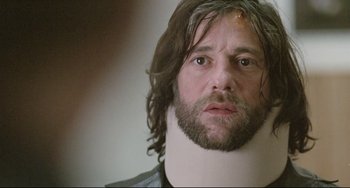 Movie still from “Head-On” (2004), directed by Fatih Akin – A person wearing a neck brace; Close Up shot, Over the shoulder angle