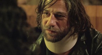Movie still from “Head-On” (2004), directed by Fatih Akin – A person wearing a neck brace; Close Up shot, Over the shoulder angle