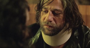 Movie still from “Head-On” (2004), directed by Fatih Akin – A person wearing a neck brace; Close Up shot, Over the shoulder angle