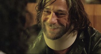 Movie still from “Head-On” (2004), directed by Fatih Akin – A person wearing a neck brace; Close Up shot, Over the shoulder angle