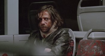 Movie still from “Head-On” (2004), directed by Fatih Akin – A man sitting on a bus with blood all over his face; Close Up shot, Low angle