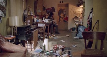 Movie still from “Head-On” (2004), directed by Fatih Akin – A room with a lot of trash on the floor; Wide shot, High angle