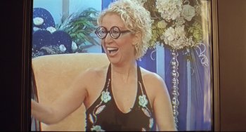 Movie still from “Head-On” (2004), directed by Fatih Akin – A woman in a black bathing suit is smiling; Medium shot, High angle