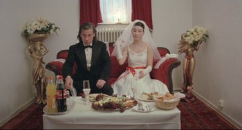 Movie still from “Head-On” (2004), directed by Fatih Akin – A man and a woman sitting at a table with food on it; Wide shot, High angle