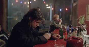 Movie still from “Head-On” (2004), directed by Fatih Akin – A group of people sitting at a table with drinks; Medium shot, Low angle