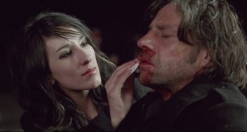 Movie still from “Head-On” (2004), directed by Fatih Akin – A woman is putting makeup on a man's face; Close Up shot, Over the shoulder angle
