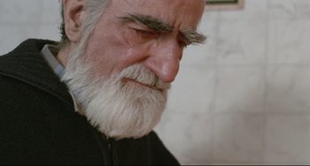 Movie still from “Head-On” (2004), directed by Fatih Akin – An old man with a beard and a white mustache; Close Up shot, Over the shoulder angle
