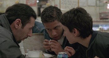 Movie still from “Head-On” (2004), directed by Fatih Akin – A group of young men sitting at a table; Close Up shot, Over the shoulder angle