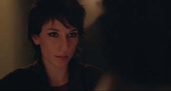 Movie still from “Head-On” (2004), directed by Fatih Akin – A person with short black hair; Close Up shot, Over the shoulder angle