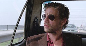 Movie still from “Head-On” (2004), directed by Fatih Akin – A person in a car wearing sunglasses; Close Up shot, Low angle