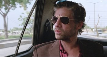 Movie still from “Head-On” (2004), directed by Fatih Akin – A person wearing sunglasses in a car; Close Up shot, Low angle