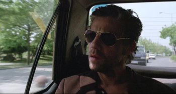 Movie still from “Head-On” (2004), directed by Fatih Akin – A person wearing sunglasses in a car; Close Up shot, Low angle