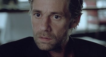 Movie still from “Head-On” (2004), directed by Fatih Akin – A person with a beard; Close Up shot, Over the shoulder angle