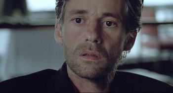 Movie still from “Head-On” (2004), directed by Fatih Akin – A person wearing a black shirt; Close Up shot, Over the shoulder angle