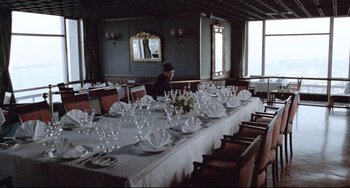 Movie still from “Head-On” (2004), directed by Fatih Akin – A man sitting at a long dining room table; Extreme Wide shot, High angle