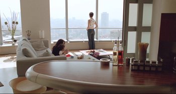 Movie still from “Head-On” (2004), directed by Fatih Akin – Two women are sitting in a living room and one woman is looking out the window; Wide shot, High angle