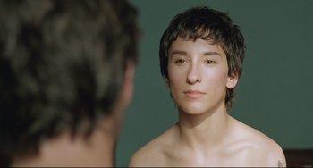 Movie still from “Head-On” (2004), directed by Fatih Akin – A young man looking at himself in the mirror; Close Up shot, Over the shoulder angle