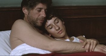 Movie still from “Head-On” (2004), directed by Fatih Akin – A man and a woman laying in a bed together; Close Up shot, Overhead angle