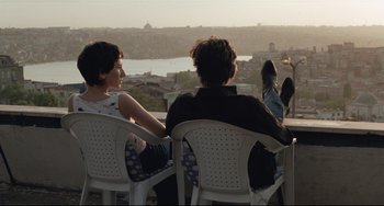 Movie still from “Head-On” (2004), directed by Fatih Akin – Two people sitting in chairs looking out over a city; Medium shot, Over the shoulder angle