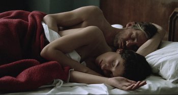 Movie still from “Head-On” (2004), directed by Fatih Akin – A man and a woman laying in bed together; Close Up shot, Overhead angle