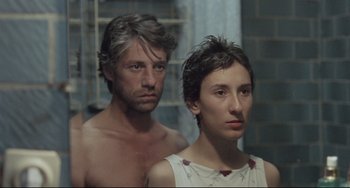 Movie still from “Head-On” (2004), directed by Fatih Akin – A man and a woman standing next to each other; Close Up shot, High angle