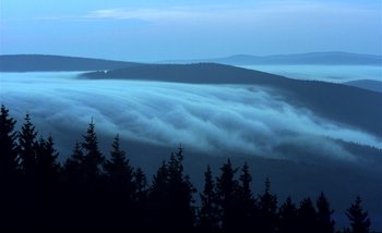 Movie still from “Heart of Glass” (1976), directed by Werner Herzog – A view of a mountain range with fog rolling in from the ground; Extreme Wide shot, High angle