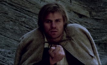 Movie still from “Heart of Glass” (1976), directed by Werner Herzog – A person wearing a cape; Close Up shot, Low angle