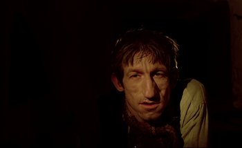 Movie still from “Heart of Glass” (1976), directed by Werner Herzog – A person wearing a jacket; Close Up shot, Low angle