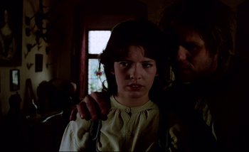 Movie still from “Heart of Glass” (1976), directed by Werner Herzog – A young girl holding a knife in front of an older man; Close Up shot, Low angle