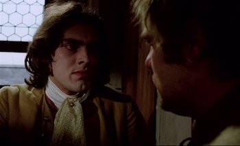 Movie still from “Heart of Glass” (1976), directed by Werner Herzog – A man in a suit and tie looking at another man in a suit and tie; Close Up shot, Over the shoulder angle