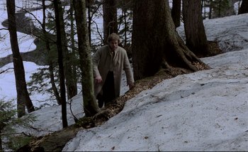 Movie still from “Heart of Glass” (1976), directed by Werner Herzog – A man standing on the side of a snow covered hill; Wide shot, High angle