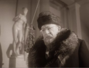 Movie still from “Heart of a Dog” (1988), directed by Vladimir Bortko – An old man wearing a fur coat and a fur hat; Close Up shot, Low angle