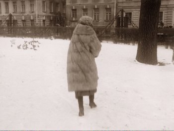 Movie still from “Heart of a Dog” (1988), directed by Vladimir Bortko – A woman in a fur coat is standing in the snow; Wide shot, High angle