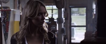 Movie still from “Tucker and Dale vs Evil” (2010), directed by Eli Craig – A woman with long blonde hair is looking into the distance; Close Up shot, Over the shoulder angle